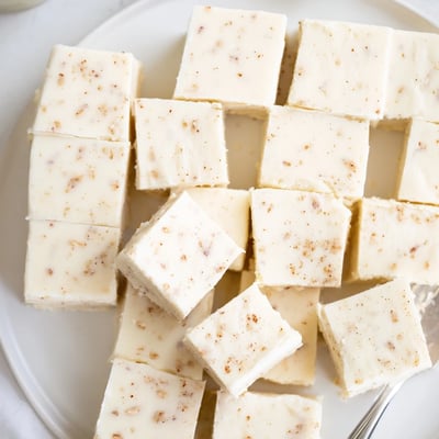 Creamy Eggnog Fudge chilled on parchment, ready to slice and serve  
